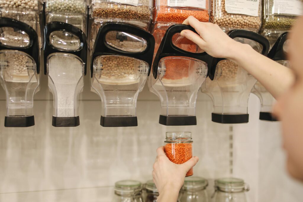 An image of someone getting lentils in bulk.