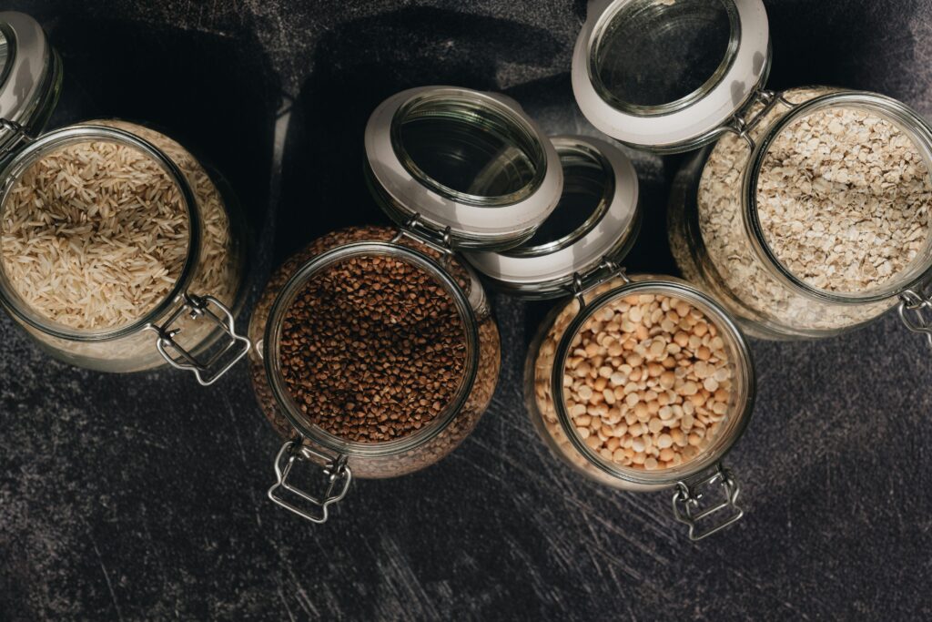 A top-down image of rice, beans, and oats in bulk.