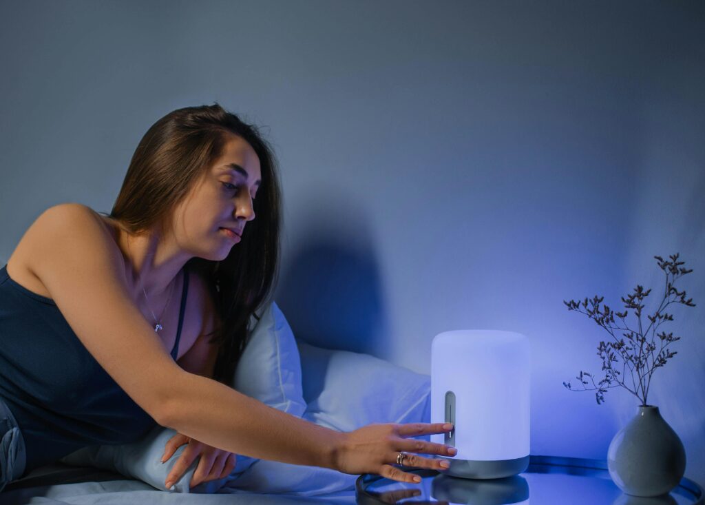 5-Ways-to-Prioritize-Health-for-a-Fulfilling-Life-Supporting An adult turns their bedside light off to get a good night's rest.