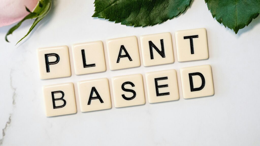 An image of white tiles with black writing that spells "plant-based."