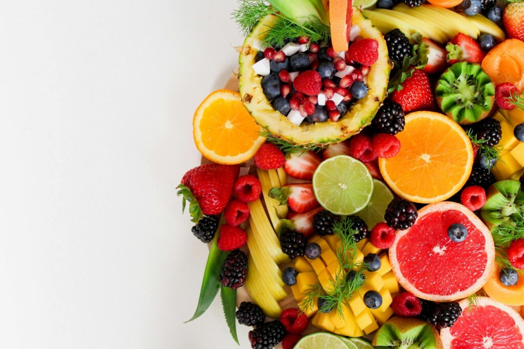 A picture of various fruits and berries arranged on a platter.