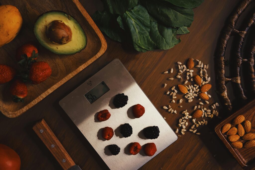 An image of various whole foods, with some being weighed on a food scale.