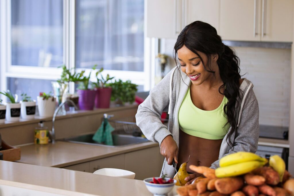 How-to-Calculate-Macros-A-Simple-Guide-for-Beginners-Supporting A healthy adult prepares some fruit for a snack.
