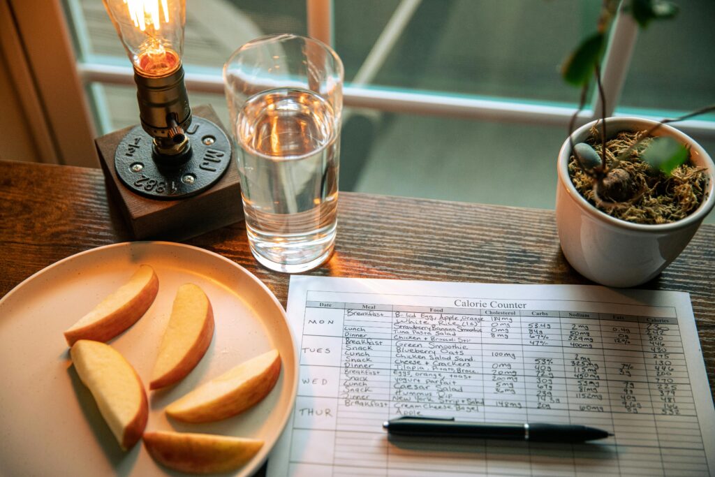An image of someone tracking their calorie intake with pen and paper.